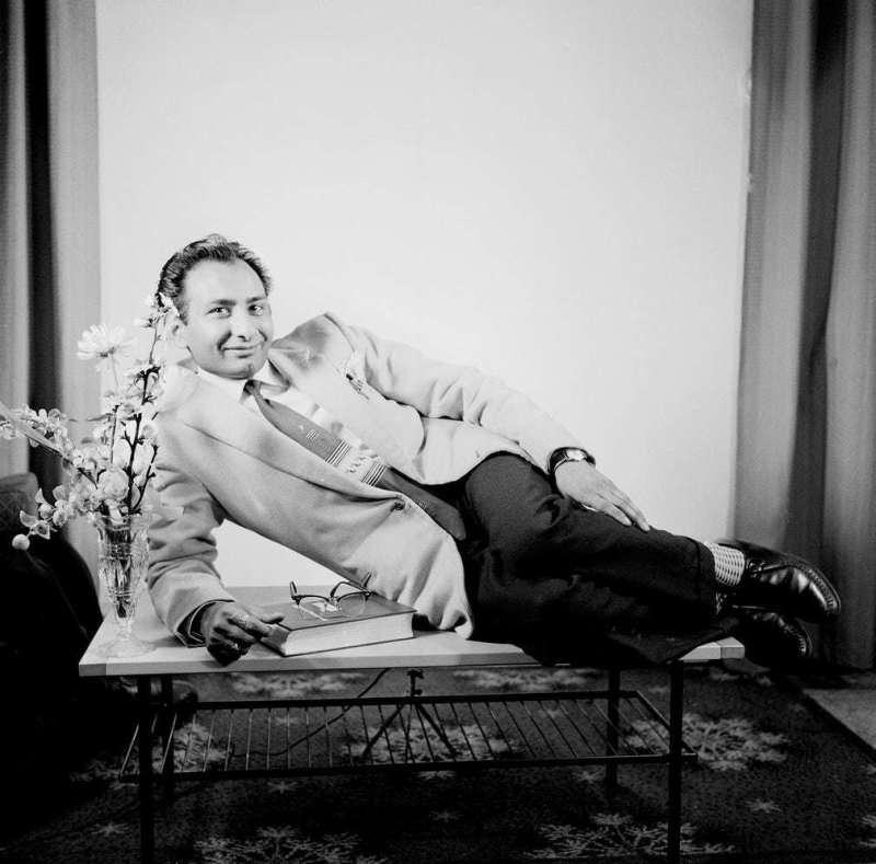 man reclines handsomely on a coffee table
